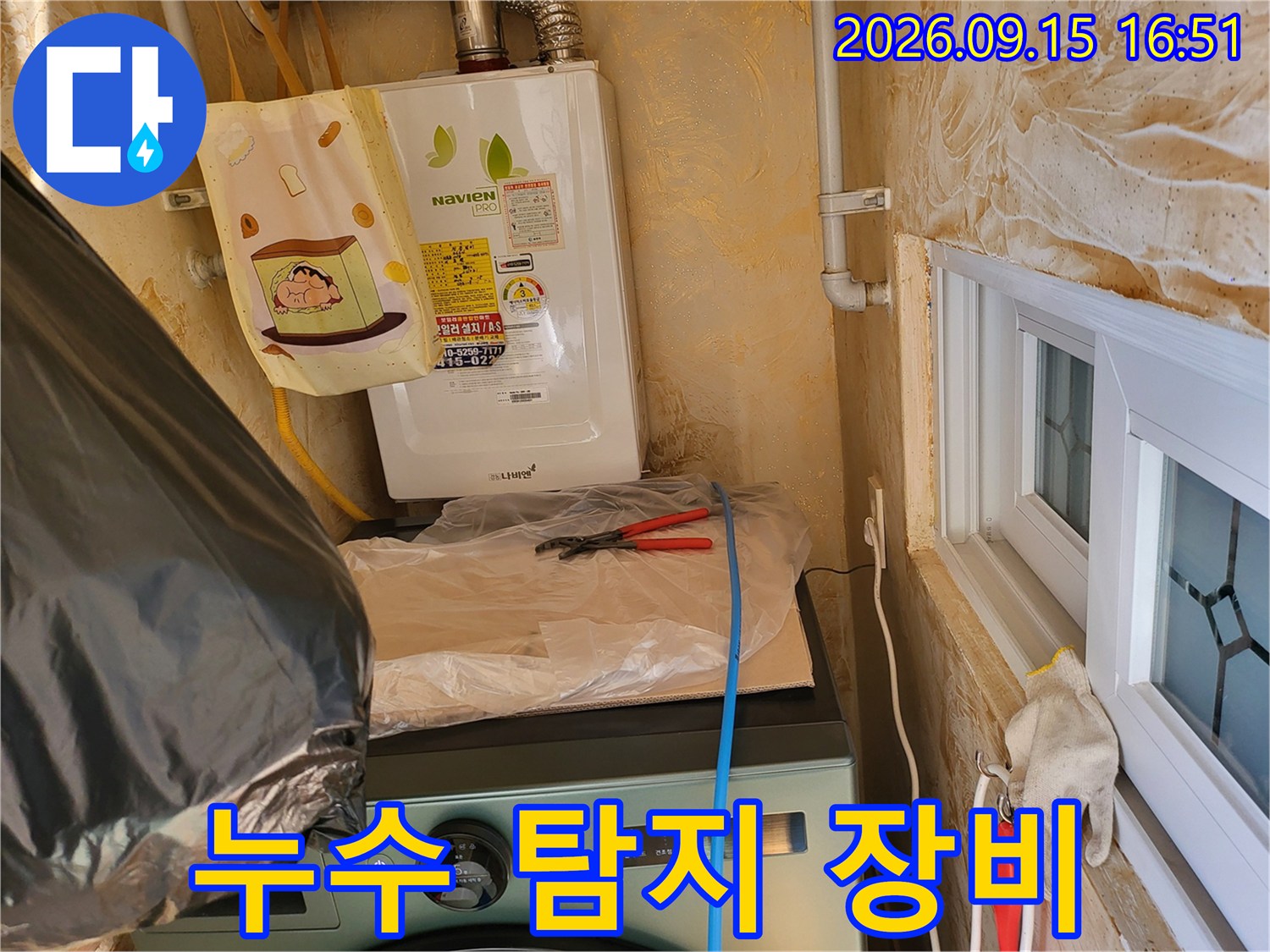 보일러 하단 배관에 연결된 노란색 호스와 가스 탐지 준비 상태입니다.